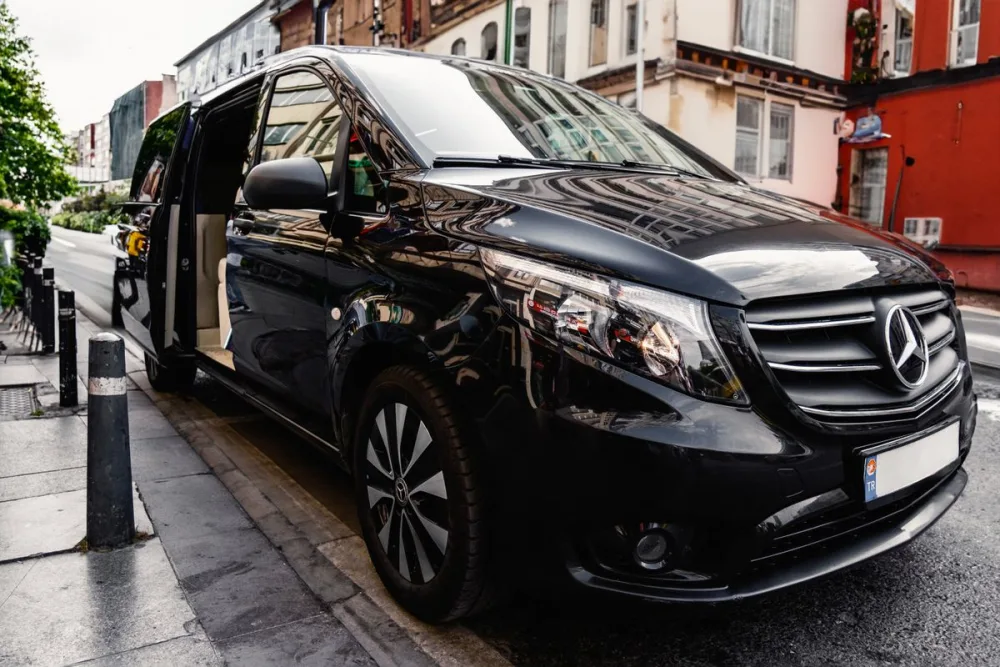 Black Mercedes Sprinter-style passenger van