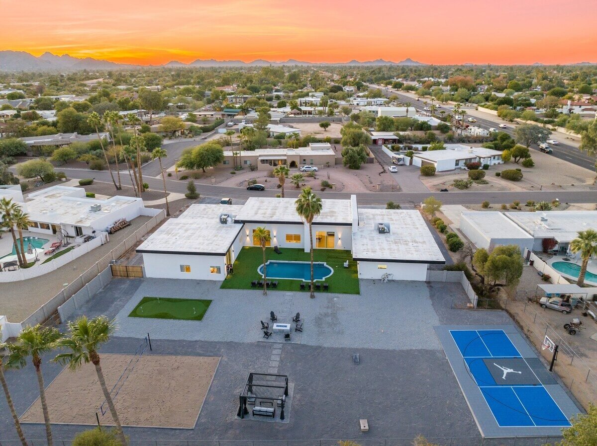 Backyard sports complex with pool, courts, and putting green at Scottsdale golf compound