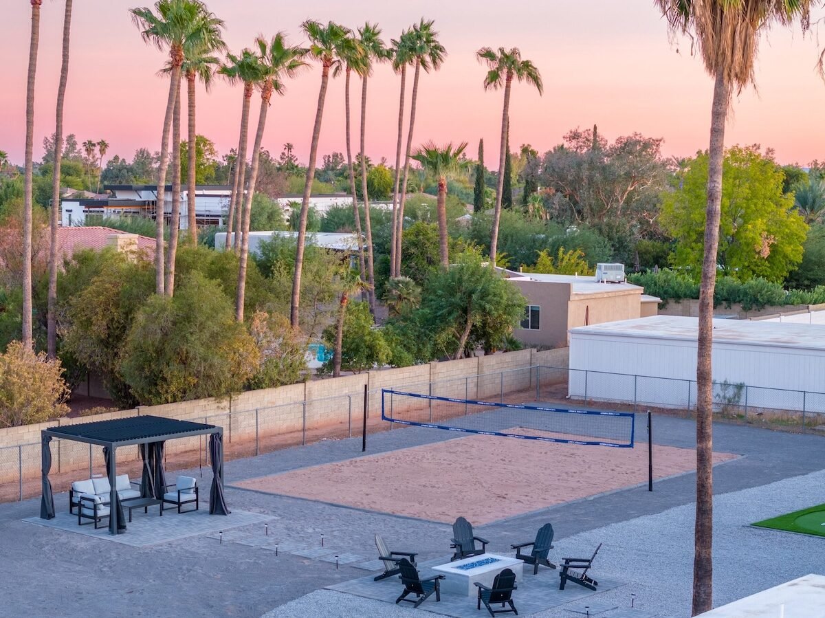 Beach volleyball court, cabana, and fire pit at private Scottsdale golf group house